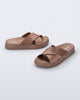 Side and angled view of a pair of brown Cozy Cross sandals with crisscross top straps