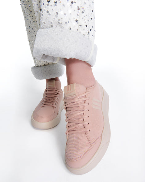Model's legs wearing a pair of pink X Mood sneakers