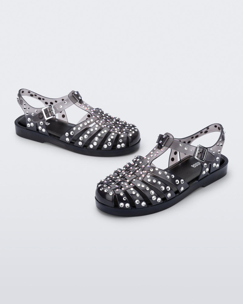 Angled view of a pair of clear black Possession Crystals sandals