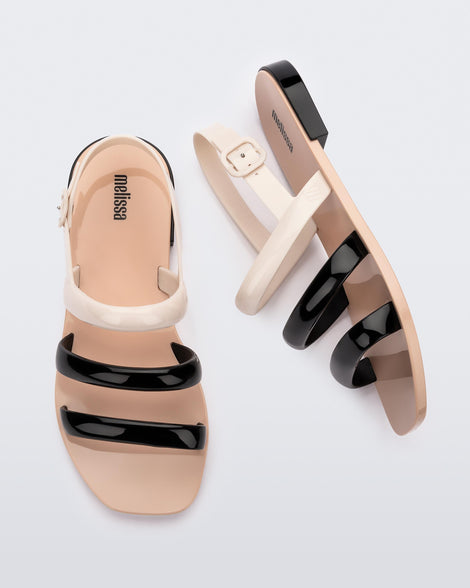 Side and top view of a pair of black and beige Essential Wave women's sandal with adjustable buckle.