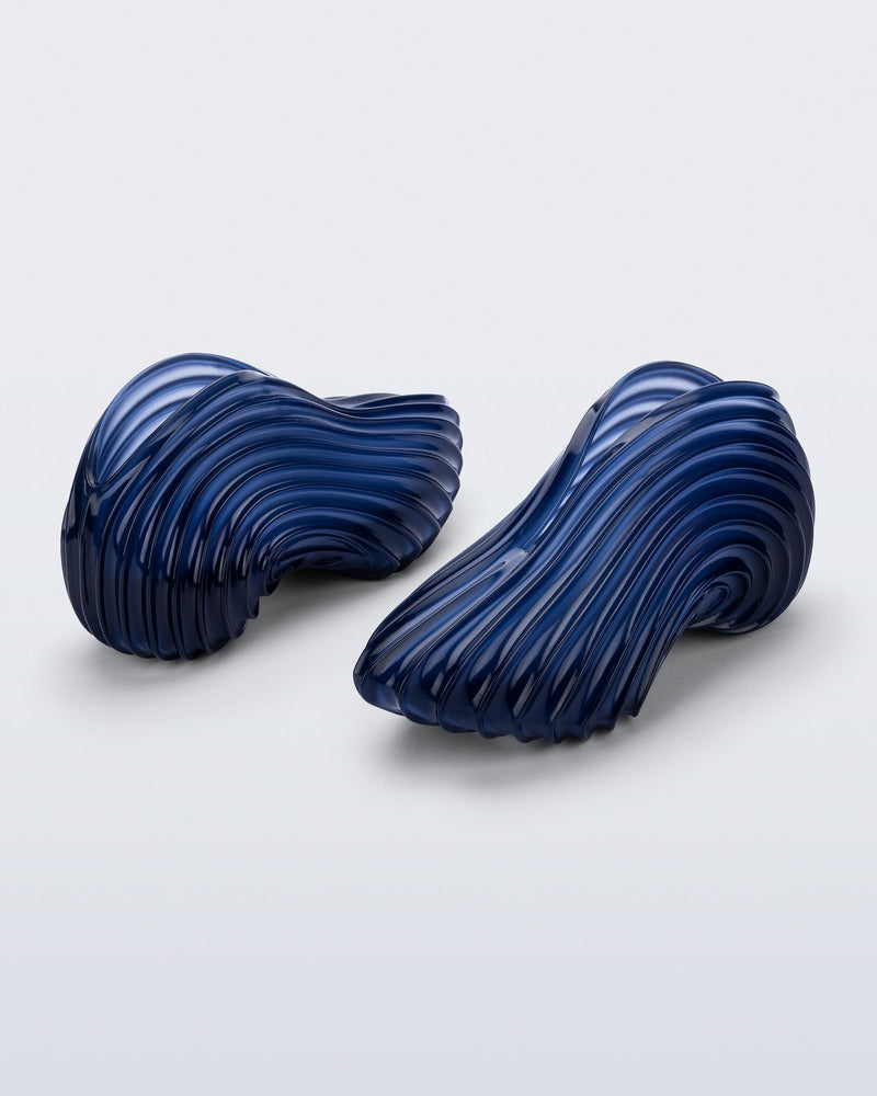 Side and back angled view of a pair of clear blue Quantum Sneakers