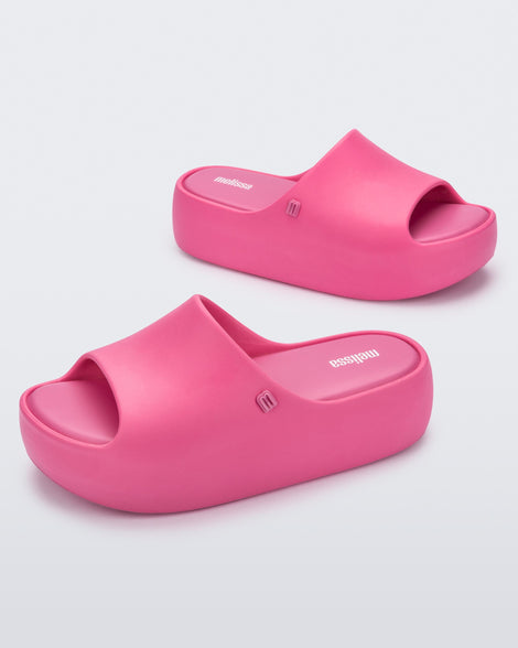 Angled view of a pair of pink Free Platform women's slides