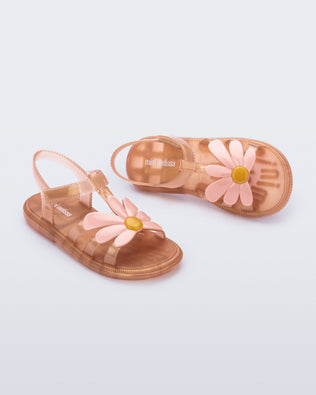 Angled view of a pair of pearly brown kids Hip Bloomy sandal.