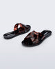 Back and angled view of a pair of black Essential Cross Slide sandals with tortoise colored straps