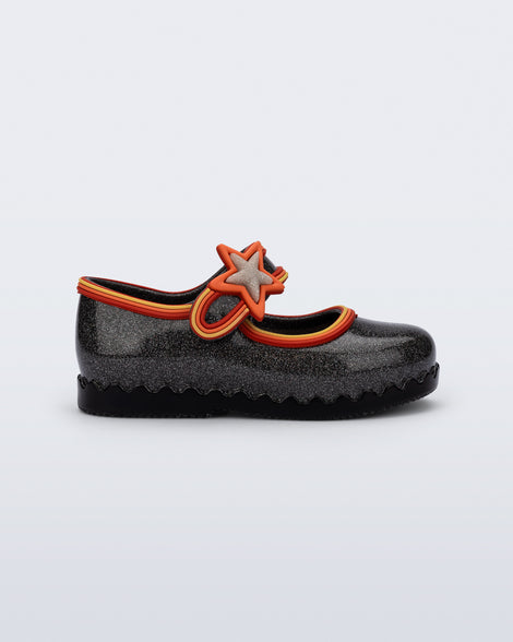 Side view of a glitter black Hip Ballerina Star baby flat with star on upper strap