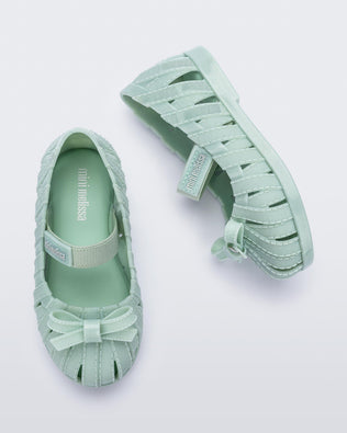 Top and side view of a pair of glitter green M Lover Ballerina baby flat with bow and strap