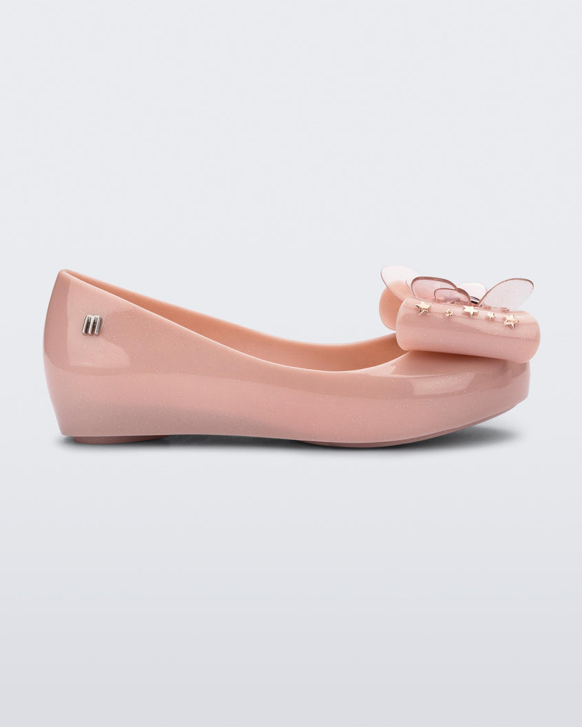 Side view of a Mini Melissa Ultragirl peeptoe ballet flat in pink with star printed butterfly bow applique. 