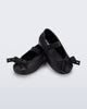 Angled view of a pair of black Sophie Crush baby ballerina flats with bow
