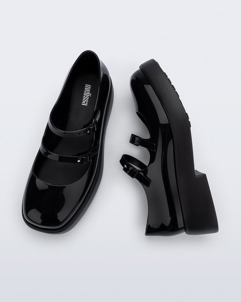 Side and top view of a pair of black Farah Low Mary jane loafers