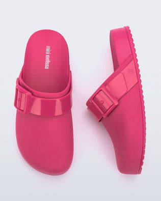 Top and side view of a pair of pink kids Cozy Clogs