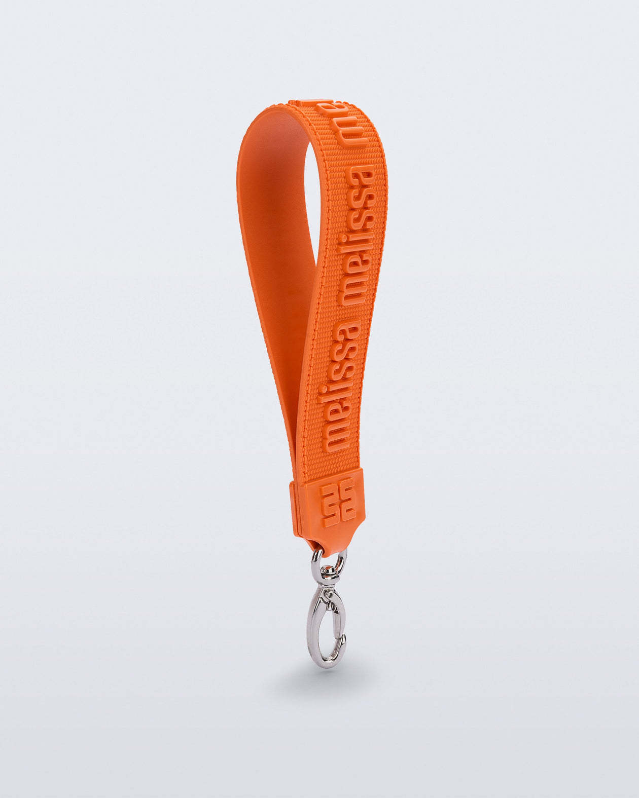 Angled view of a orange M Lover Charm with the Melissa logo