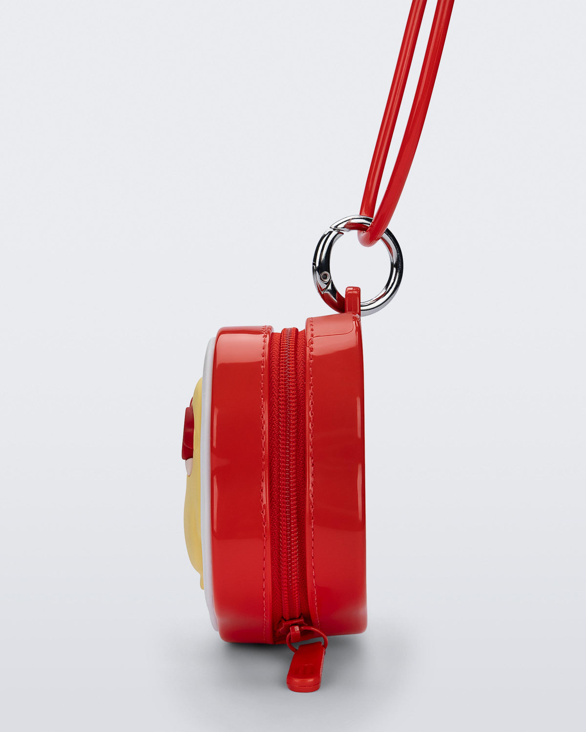 Side view of a red Bag + Pop Mart Pucky small bag with short strap