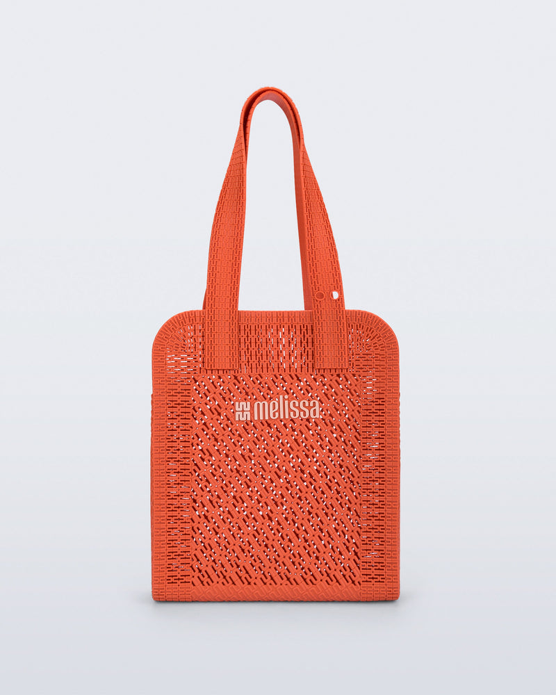 Front view of an orange Harper bag with shoulder straps