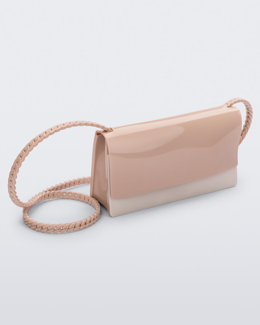 Angled view of the Melissa party handbag in beige with braided strap.