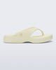 Side view of a beige Free Thong Low flip flop