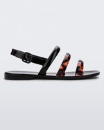 Side view of black and tortiose Essential Wave women's sandal with adjustable buckle.