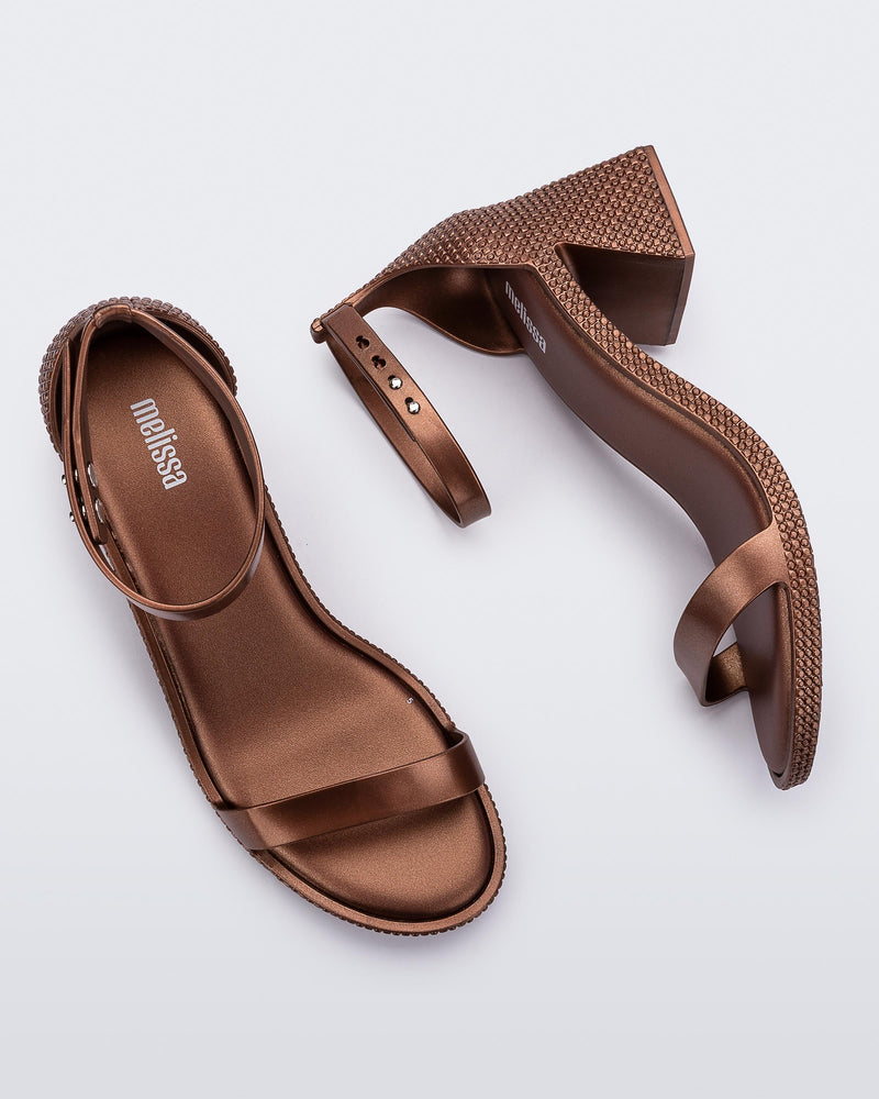Top and side view of a pair of metallic copper Lux Heels