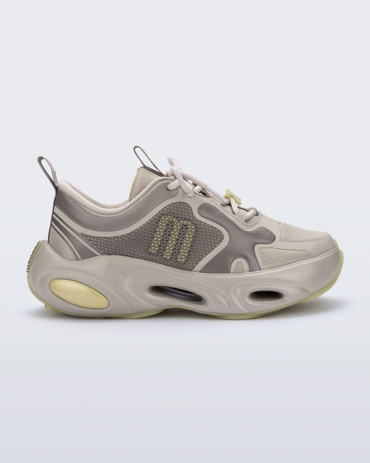 Side view of an beige X Loop sneaker