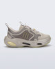 Side view of an beige X Loop sneaker