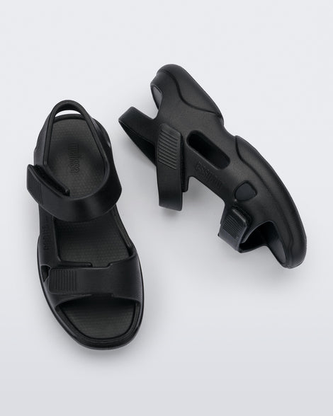 Top and side view of a pair of black Free Papete sandals