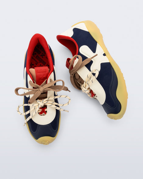 Top and side view of a pair of black and beige X Bend sneakers with yellow sole