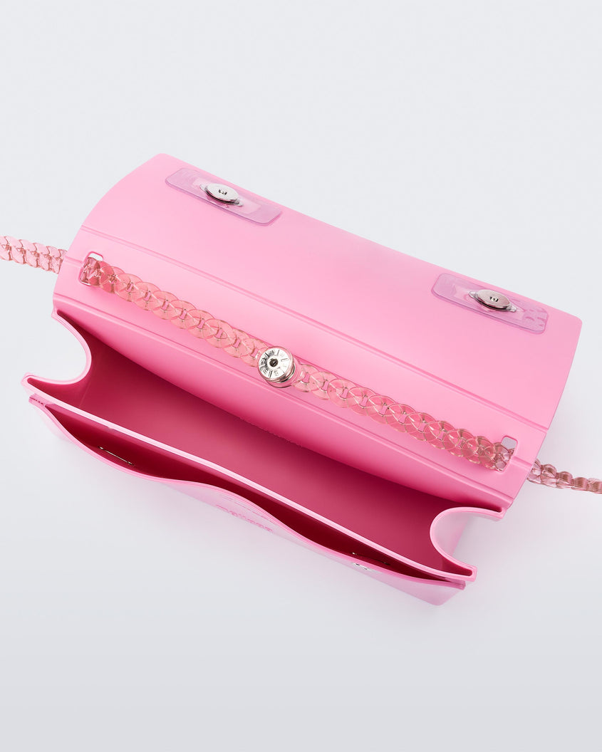 Inside view of the Melissa party handbag in pink with main interior pocket and front small pocket