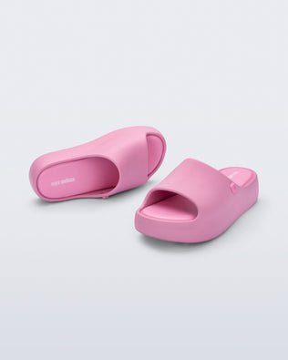 Angled top and front view of a pair of pink Free Platform Slide kids sandals