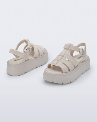 Back and angled view of a pair of light beige Up Platform sandals