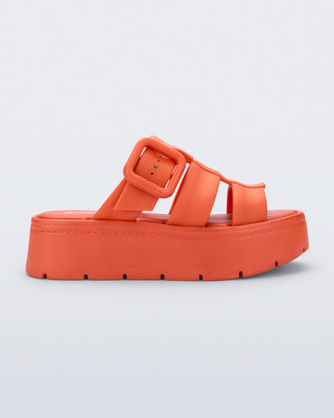 Side view of an orange Pump Platform sandal