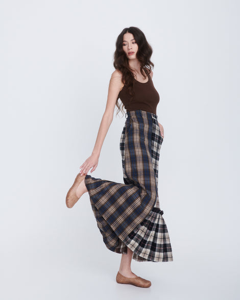 Model in a plaid brown long skirt and brown tank wearing a pair of clear beige Campana Papel Hug flats