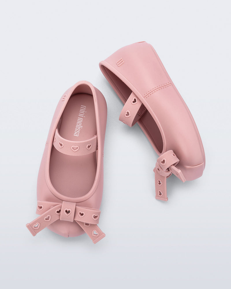 Top and side view of a pair of pink Sophie Crush baby ballerina flats with bow