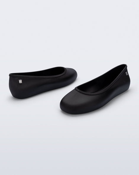 Back and angled view of a pair of black Soft Ballerina Essential flats