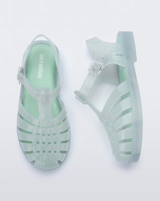 Side and top view of a pair of light green kids Possession sandals.