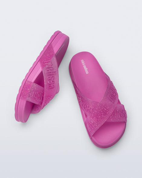 Side and top view of a pair of pink Cozy M Lover Slides with Melissa on the upper