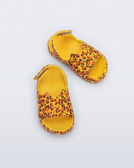 Top view of a pair of yellow Free Cute baby sandals with leopard print