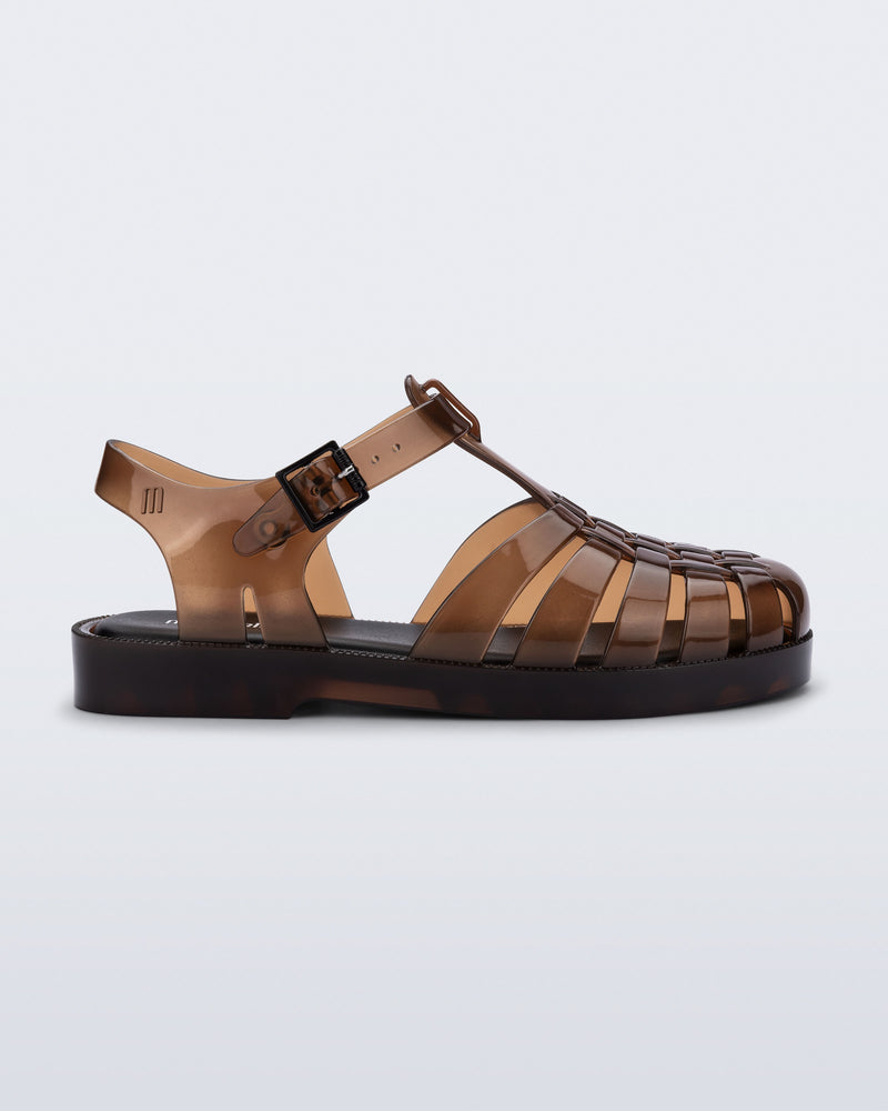 Side view of a transparent brown Possession kids sandal