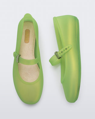 Top and side view of a pair of green Soft adult flats with strap and green buckle
