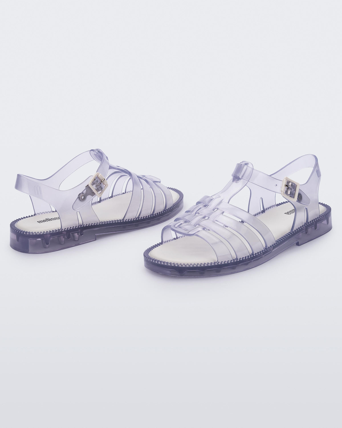 Angled view of a pair of clear Possession Fresh fisherman style sandals with open toe.