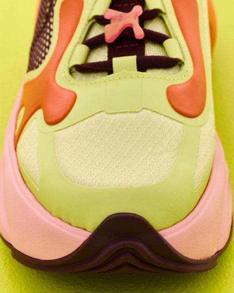 Up close view of the front of an orange/green/pink X Loop sneaker