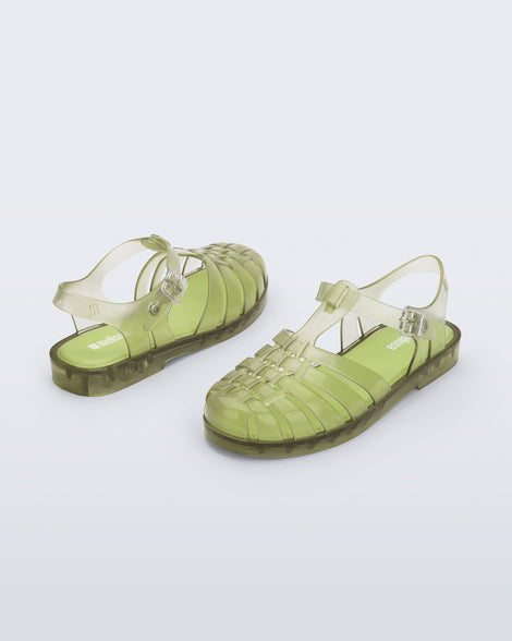 Back and angled view of a pair of transparent green Possession fisherman sandals