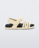 Side view of a beige with black insole Kaiteki baby sandal