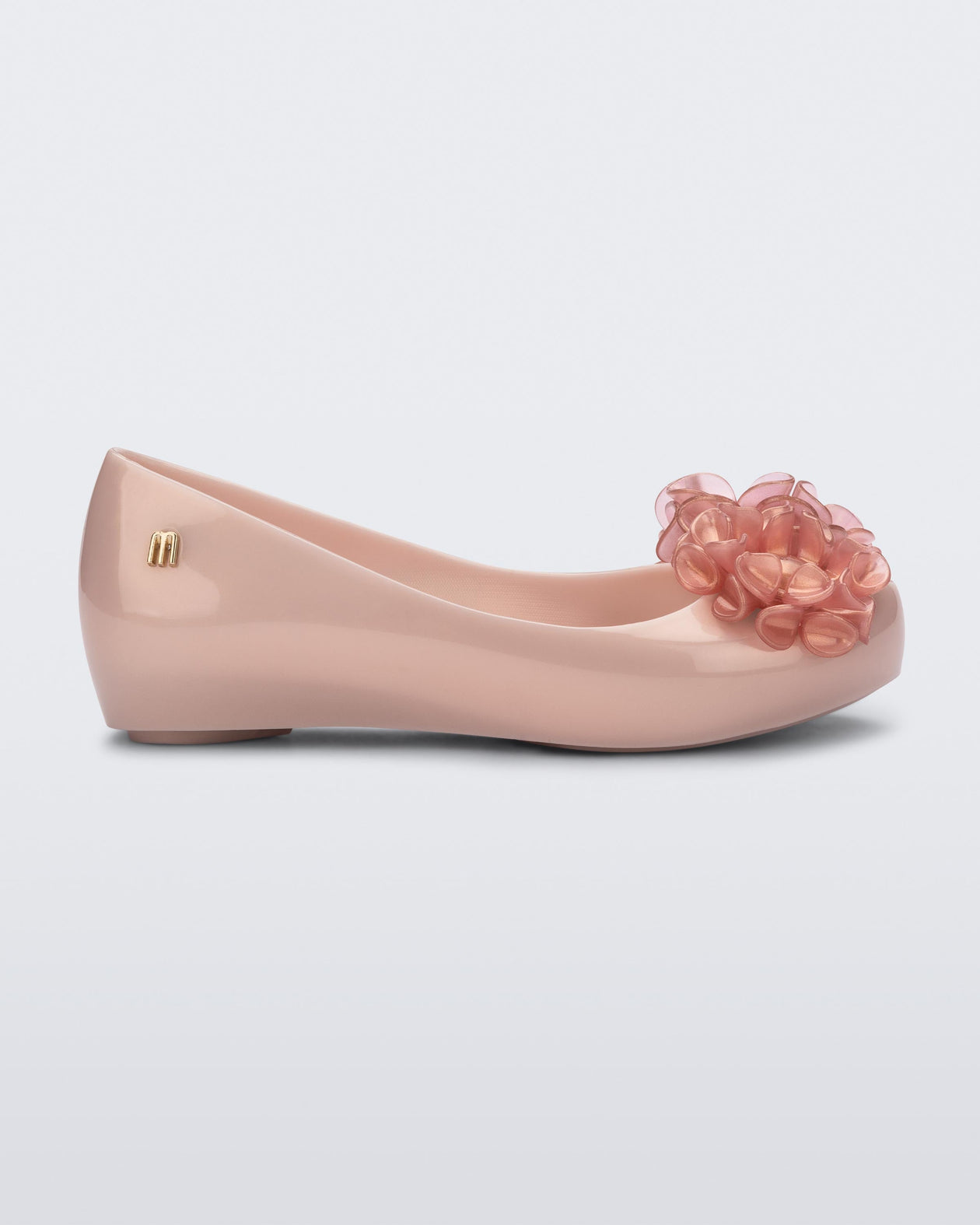 Side view of a pearly pink Ultragirl Springtime kids flat with two clear pink flowers and peep toe.