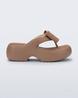 Side view of a brown Free Fuzzy Platform flip flop 