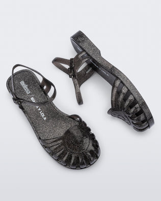 Top and side view of a pair of the glitter black Sandal + Bimba y Lola with ankle strap