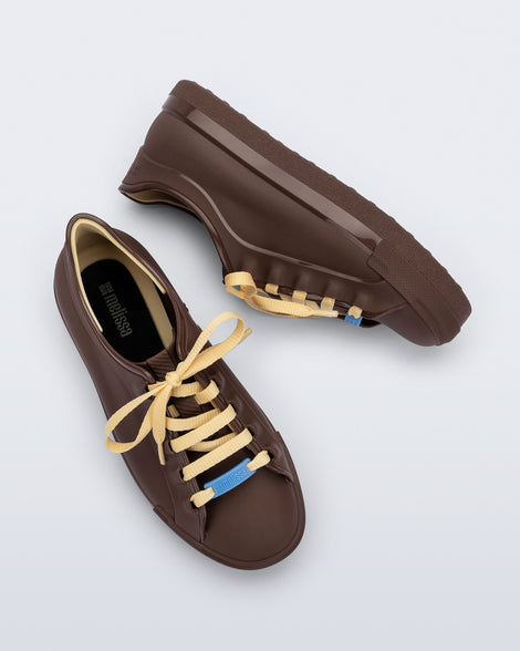 Top and side view of a pair of brown Wow Sneakers with beige laces