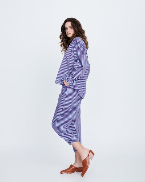 Model in a blue outfit wearing a pair of brown Texas Mule heels