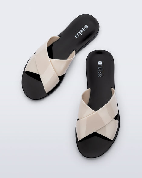 Top view of a pair of black Essential Cross Slide sandals with beige colored straps