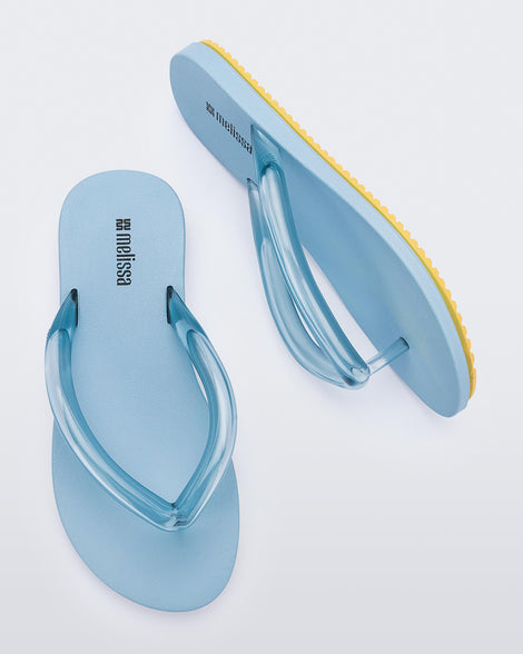 Top and side view a pair of blue Flip Flop Airflow sandals with a clear blue strap and yellow bottom