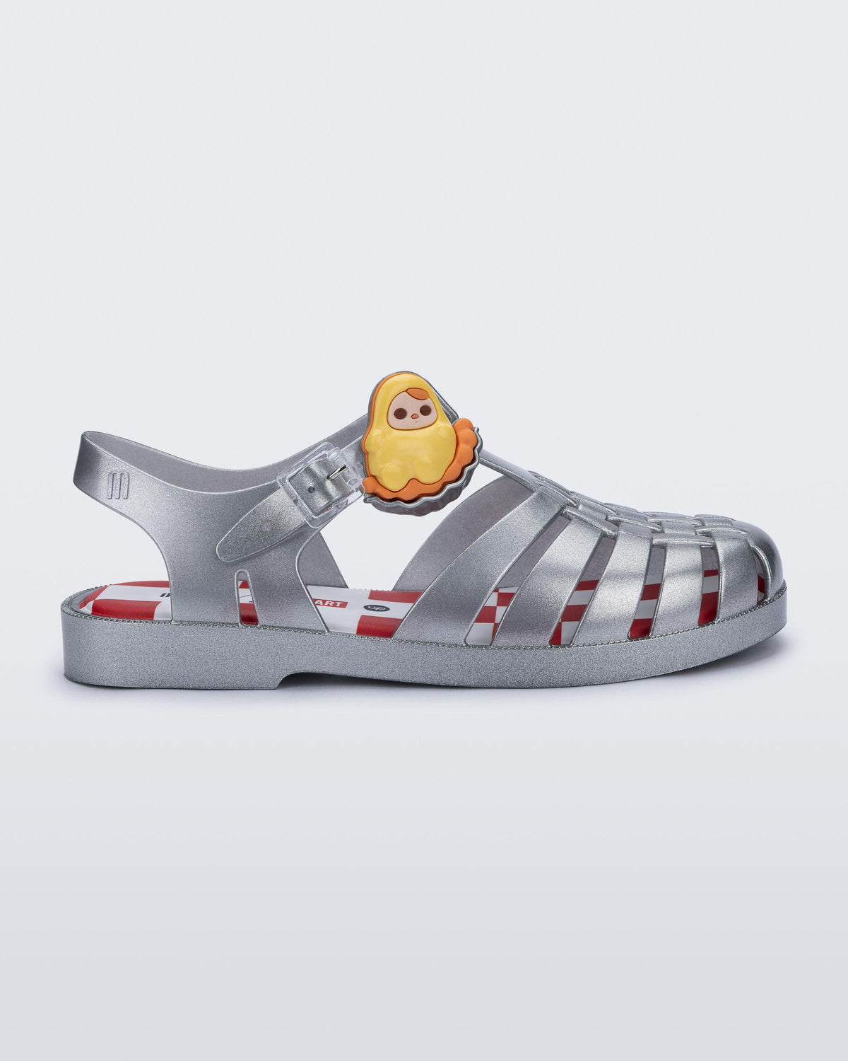 Side view of a silver Possession + Pop Mart Pucky fisherman sandal
