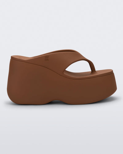 Side view of a brown Free Thong Wedge platform flip flop sandal